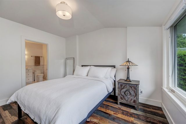 a bed sitting in a bedroom next to a window