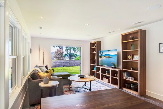 a living room with furniture a lamp and a large window