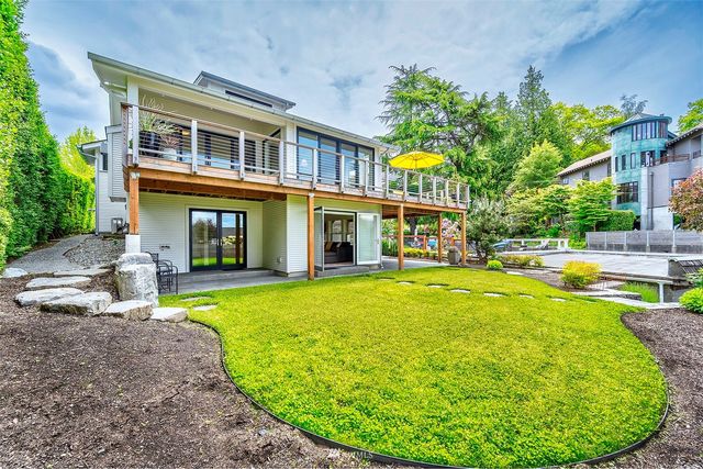 a view of a house with swimming pool and sitting area