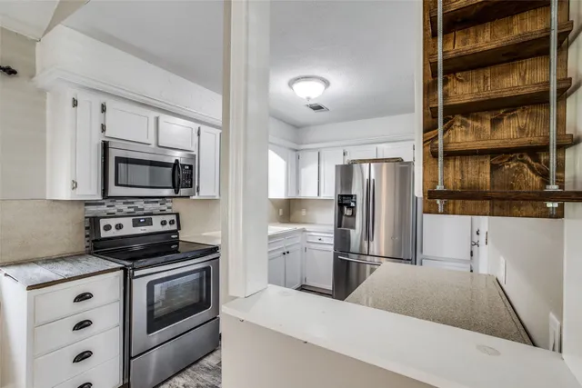a kitchen with a refrigerator stove and microwave