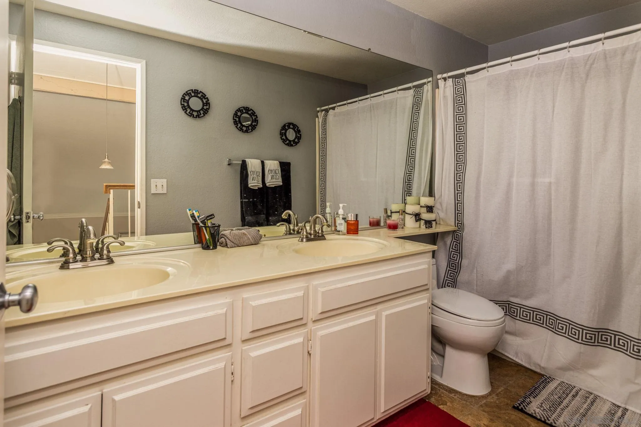 4648 Valley Glen Drive Corona, CA 92878 - Photo 20 of 42 a bathroom with a sink and a mirror