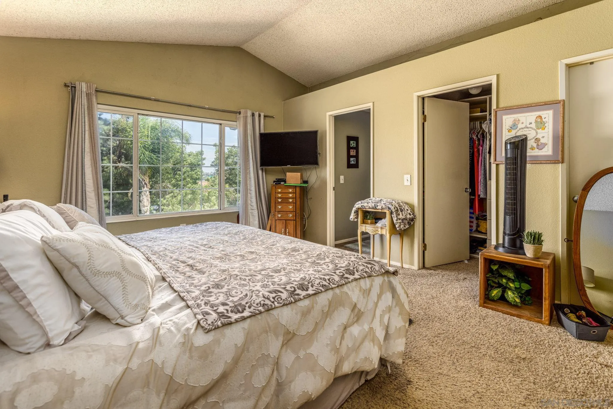 4648 Valley Glen Drive Corona, CA 92878 - Photo 22 of 42 a bedroom with a bed a flat screen tv and a large window