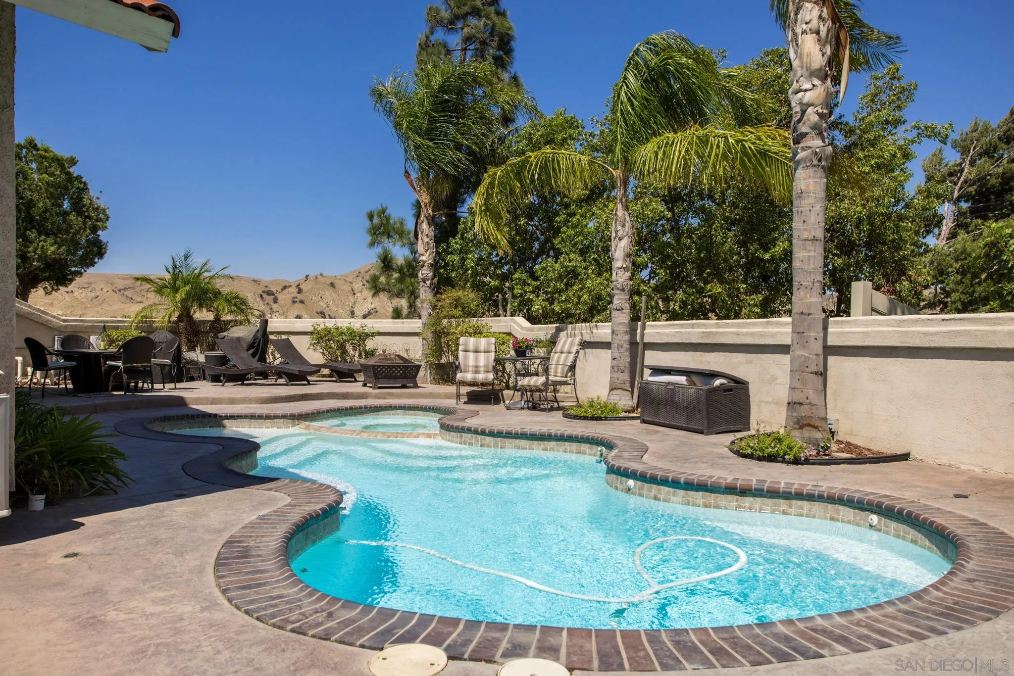 4648 Valley Glen Drive Corona, CA 92878 - Photo 26 of 42 a view of a swimming pool with sitting area