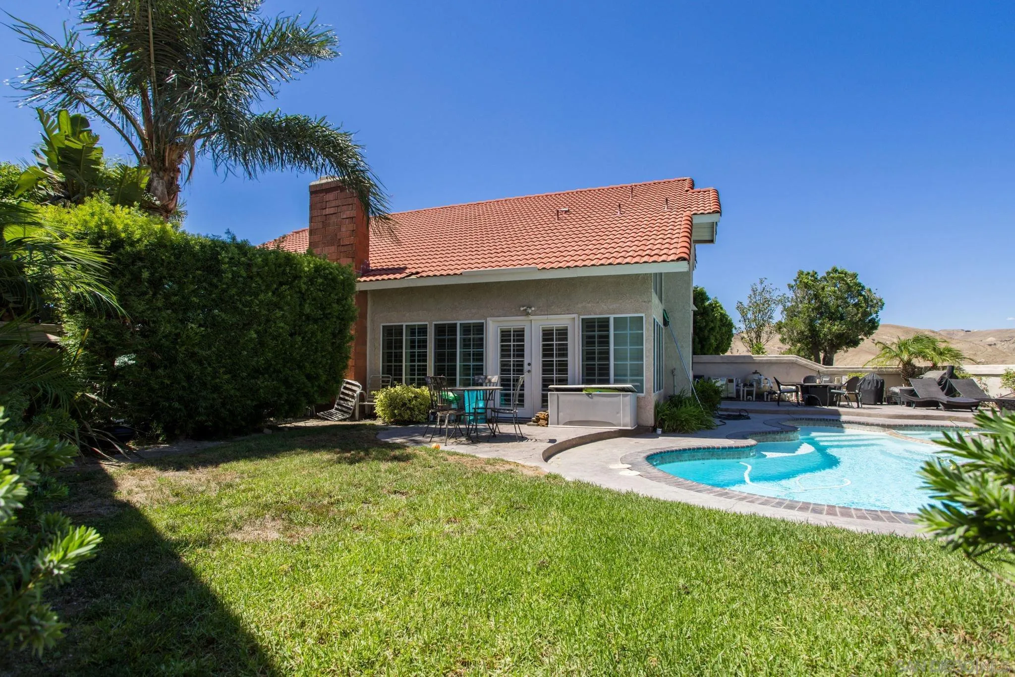 4648 Valley Glen Drive Corona, CA 92878 - Photo 28 of 42 a view of a house with backyard sitting area and swimming pool