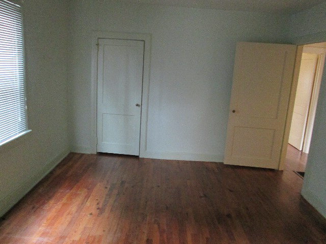 6121 Forsyth Road Macon, GA 31210 - Photo 16 of 17 an empty room with wooden floor and window
