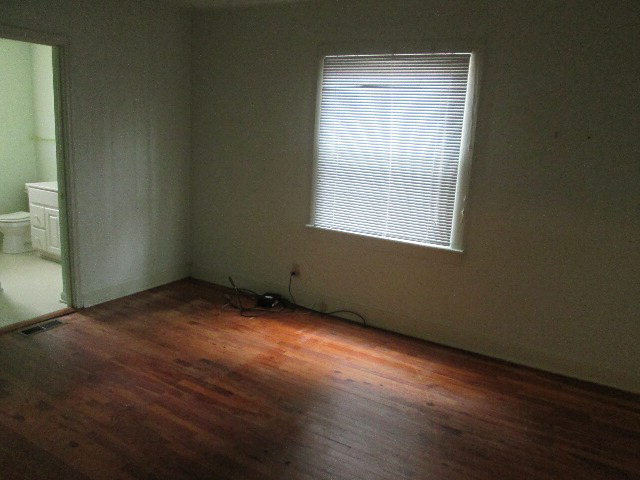 6121 Forsyth Road Macon, GA 31210 - Photo 17 of 17 an empty room with wooden floor and windows