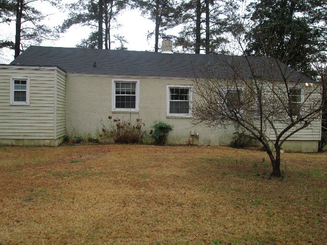 6121 Forsyth Road Macon, GA 31210 - Photo 3 of 17 a view of a house with a yard and garage