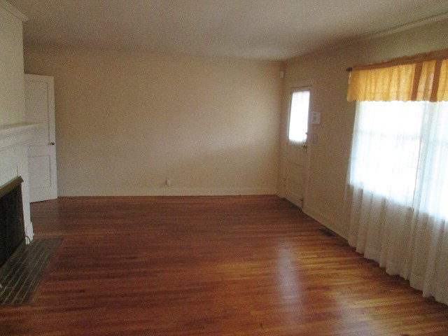 6121 Forsyth Road Macon, GA 31210 - Photo 7 of 17 a view of an empty room with wooden floor and a window