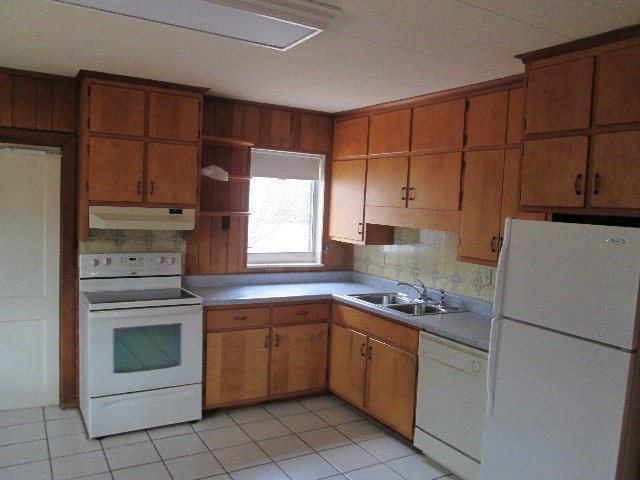 6121 Forsyth Road Macon, GA 31210 - Photo 10 of 17 a kitchen with a stove sink and cabinets
