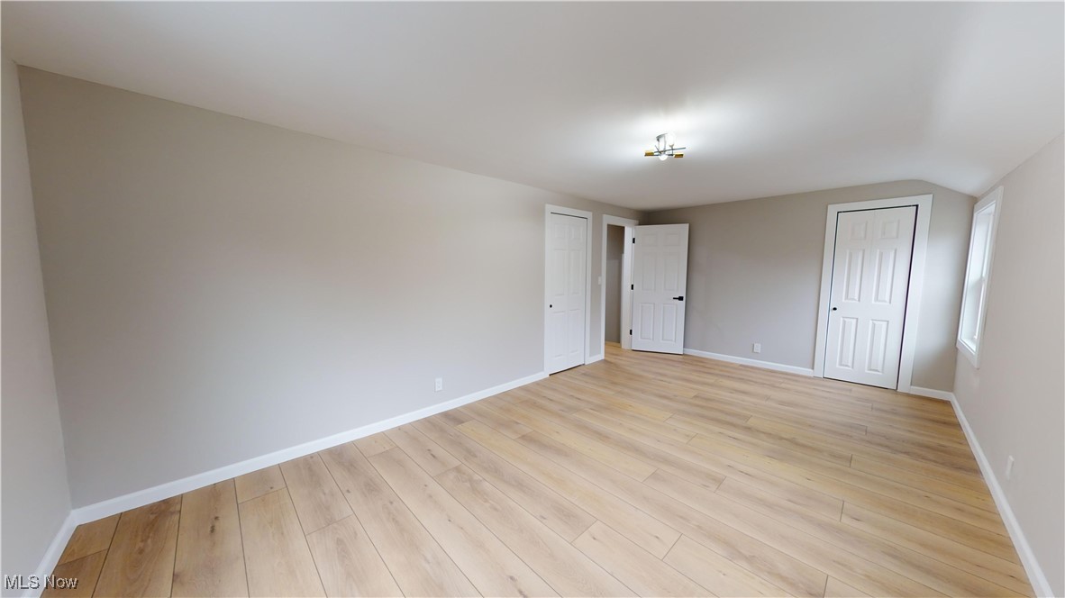 5252 Spencer Road Cleveland, OH 44124 - Photo 23 of 33 Spare room featuring lofted ceiling and light hardwood / wood-style flooring