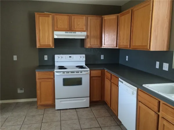 a kitchen with a cabinets and white stove