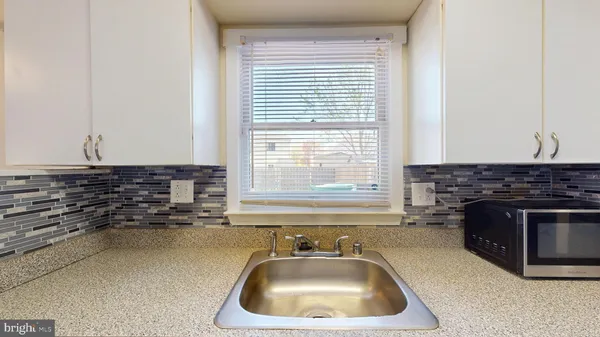 a kitchen with a sink and a stove