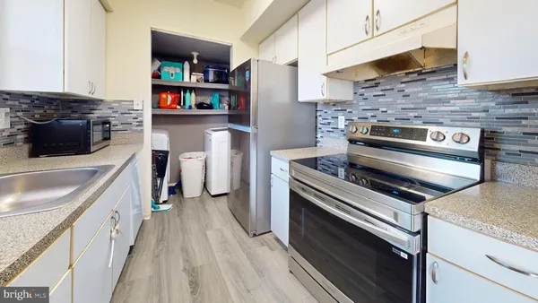 a kitchen with stainless steel appliances a stove microwave and a refrigerator