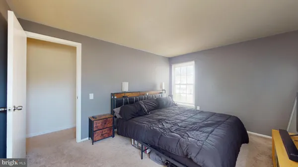 a bedroom with a bed and window