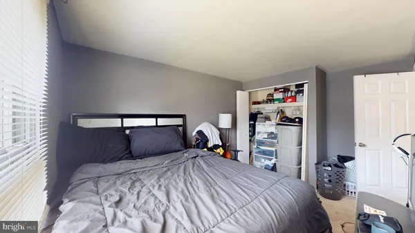 a bedroom with a bed and a closet