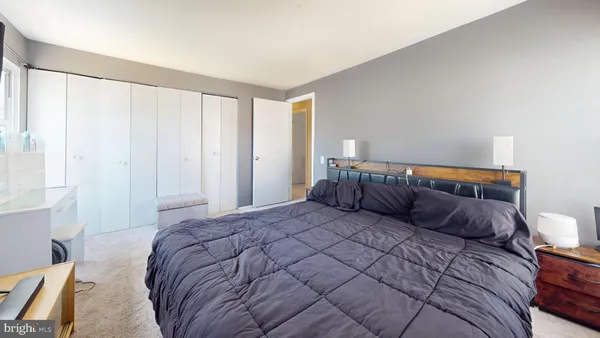 a bedroom with a large bed and a couch chair