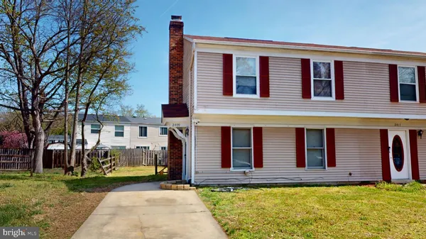 a view of a house with a large window and a yard