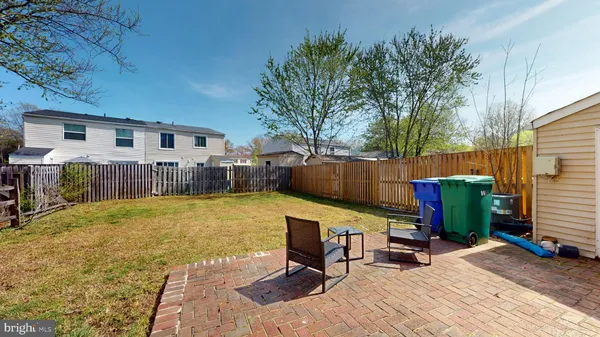 a view of a backyard with furniture and a grill