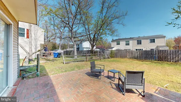 a swimming pool with outdoor seating and yard
