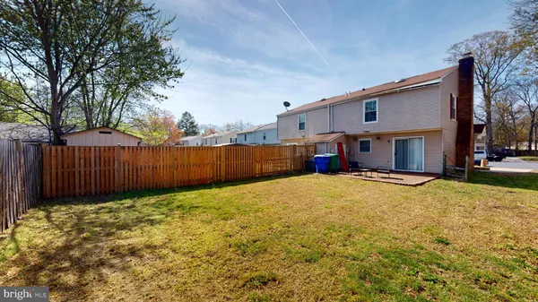a view of a house with backyard and tree