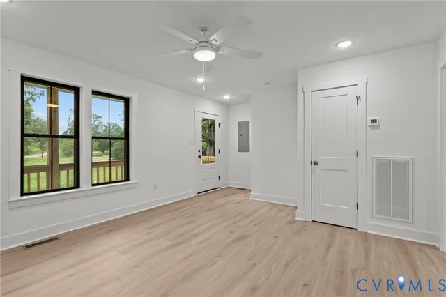 a view of an empty room with wooden floor