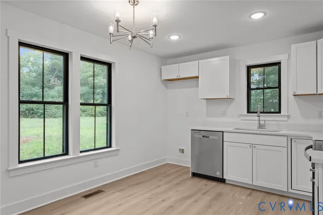 a view of a kitchen with a sink stainless steel appliances and cabinets