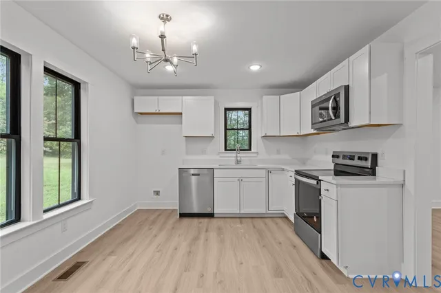 a kitchen with stainless steel appliances a stove and a microwave