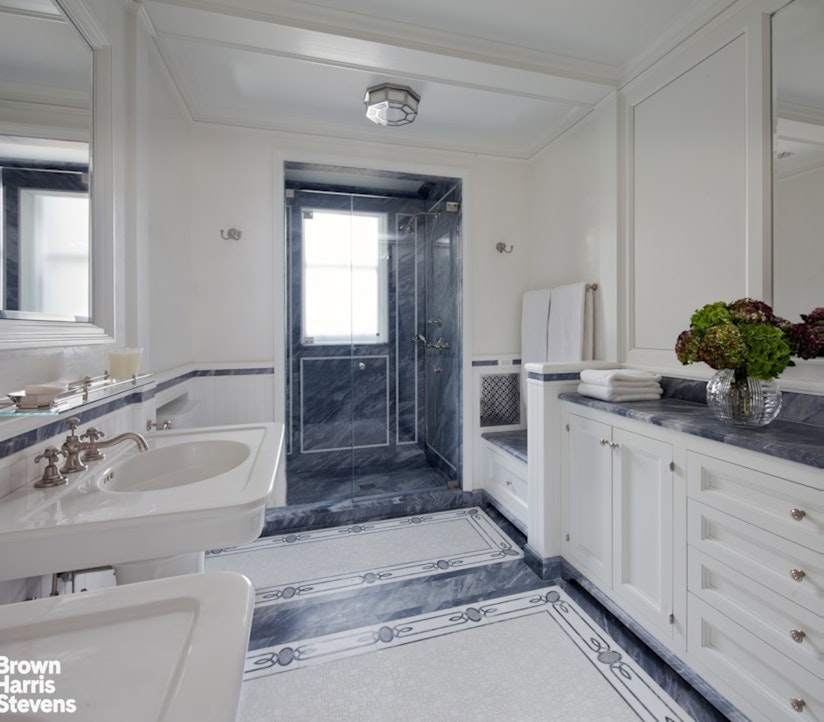 912 5th Avenue, Unit 10 Manhattan, NY 10021 - Photo 11 of 20 a spacious bathroom with a granite countertop sink and a mirror