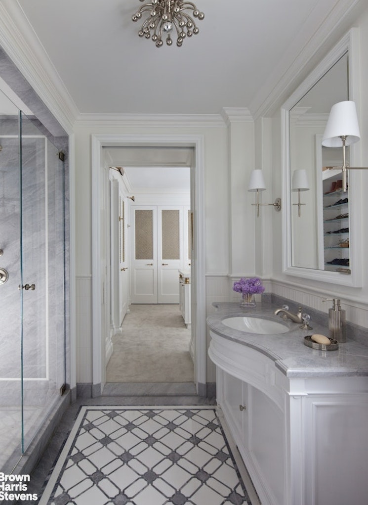 912 5th Avenue, Unit 10 Manhattan, NY 10021 - Photo 16 of 20 a bathroom with a sink and a mirror