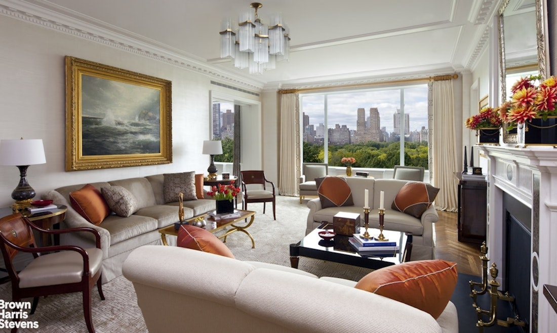 912 5th Avenue, Unit 10 Manhattan, NY 10021 - Photo 3 of 20 a living room with furniture a fireplace and a floor to ceiling window