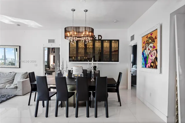 a view of a dining room with furniture and chandelier
