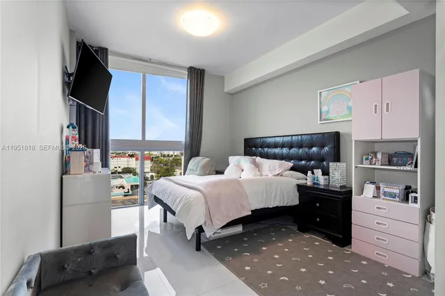 a bedroom with a bed and dresser