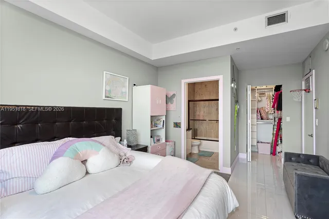 a bedroom with a bed and walk in closet