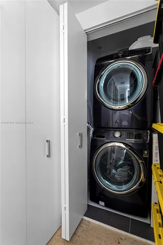 a view of a balcony with furniture and a floor to ceiling window