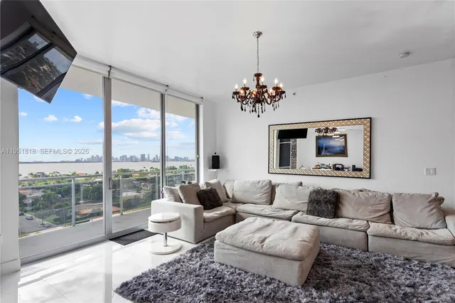 a view of swimming pool with outdoor seating and plants