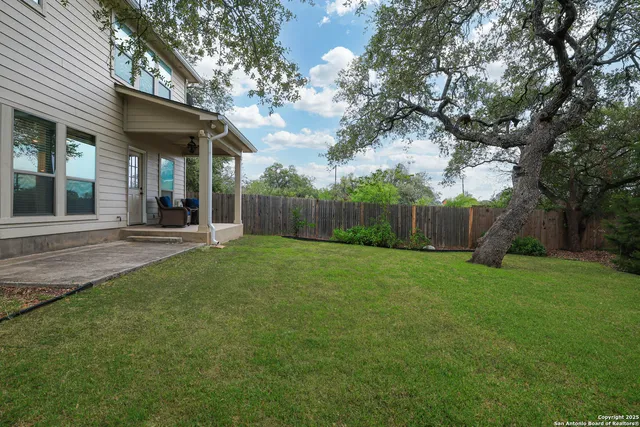 a view of a house with a backyard
