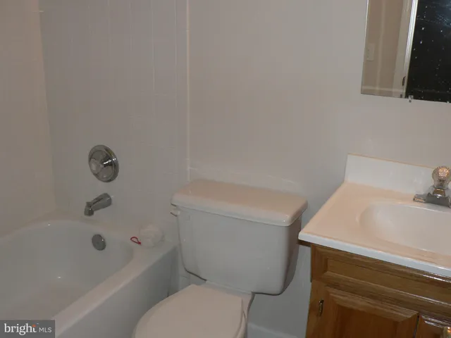 a bathroom with a sink a toilet and bathtub