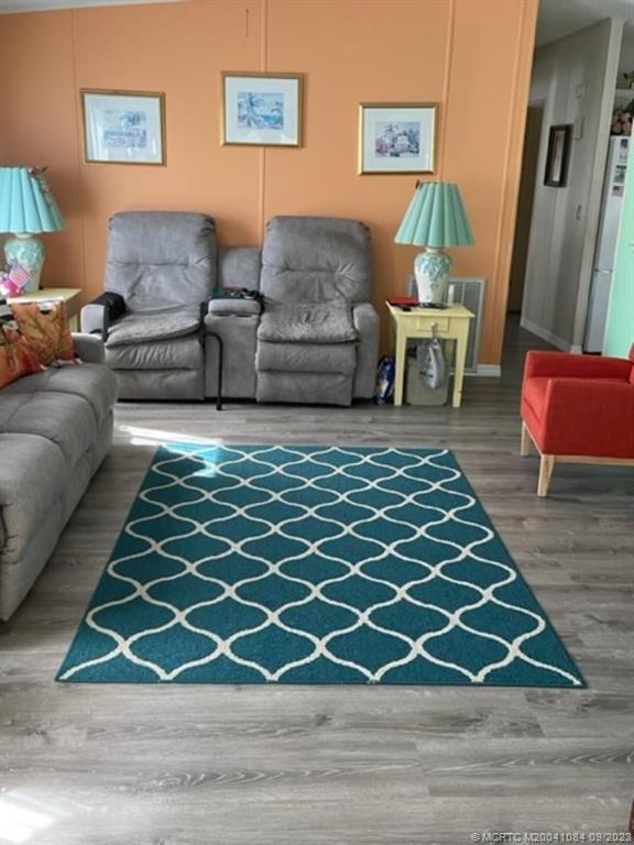 2526 Southwest Olds Place Stuart, FL 34997 - Photo 3 of 11 a living room with a couch and a rug