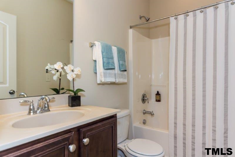 4221 Fares Wall Court Raleigh, NC 27616 - Photo 15 of 25 a bathroom with a sink toilet and shower