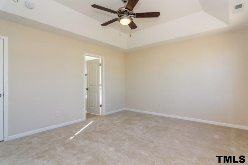 4221 Fares Wall Court Raleigh, NC 27616 - Photo 17 of 25 an empty room with closet and a chandelier fan