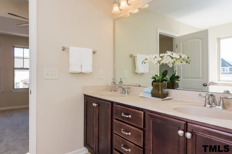 4221 Fares Wall Court Raleigh, NC 27616 - Photo 18 of 25 a bathroom with a sink a vanity and a mirror