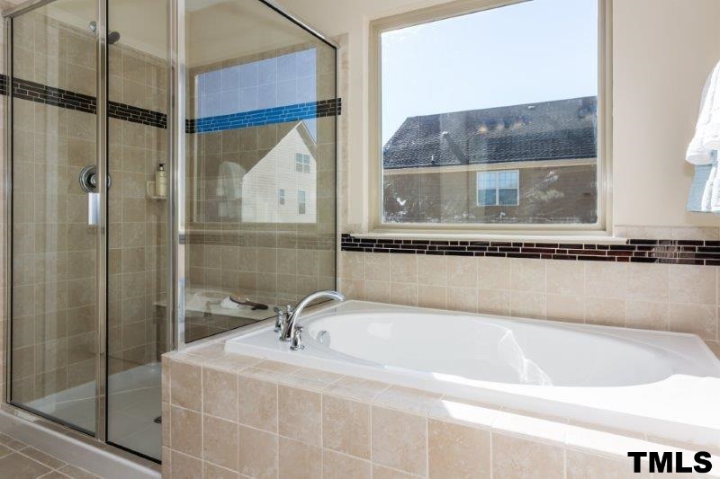 4221 Fares Wall Court Raleigh, NC 27616 - Photo 19 of 25 a bathroom with a tub and a sink