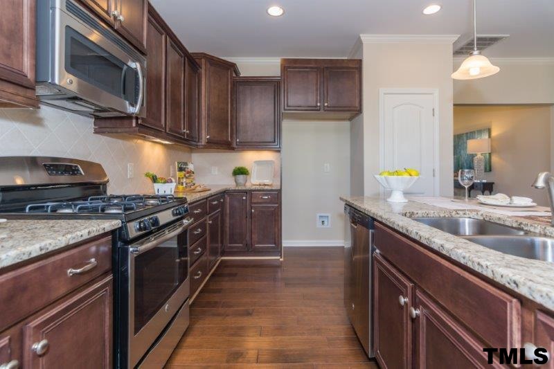 4221 Fares Wall Court Raleigh, NC 27616 - Photo 9 of 25 a kitchen with stainless steel appliances granite countertop a stove a sink dishwasher and a refrigerator