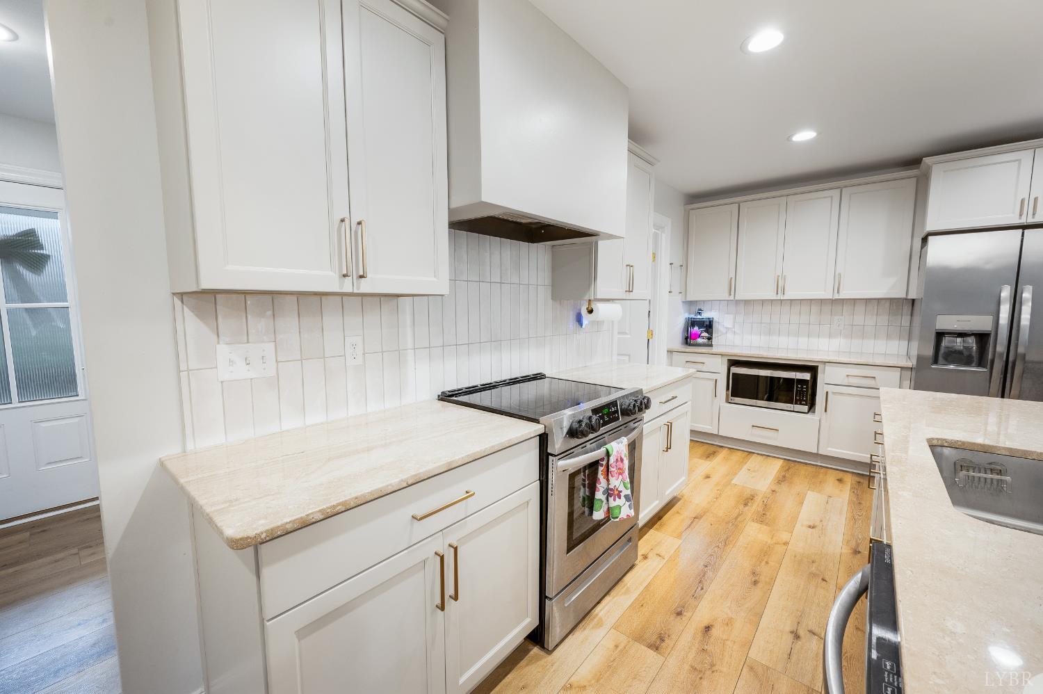 240 Ned Brown Road Amherst, VA 24521 - Photo 14 of 53 a kitchen with a stove sink and a refrigerator