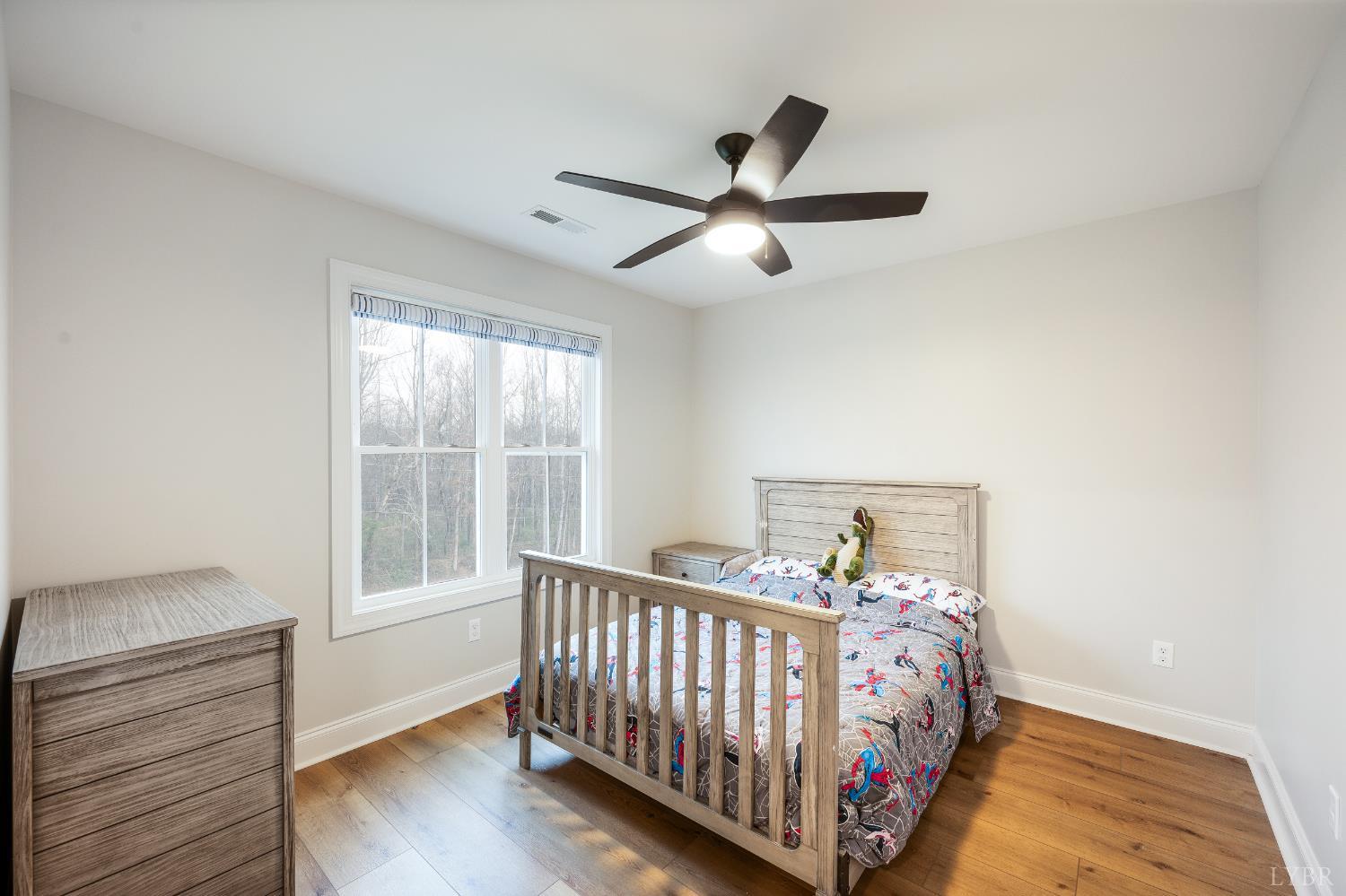 240 Ned Brown Road Amherst, VA 24521 - Photo 31 of 53 a bed sitting in a bedroom next to a window