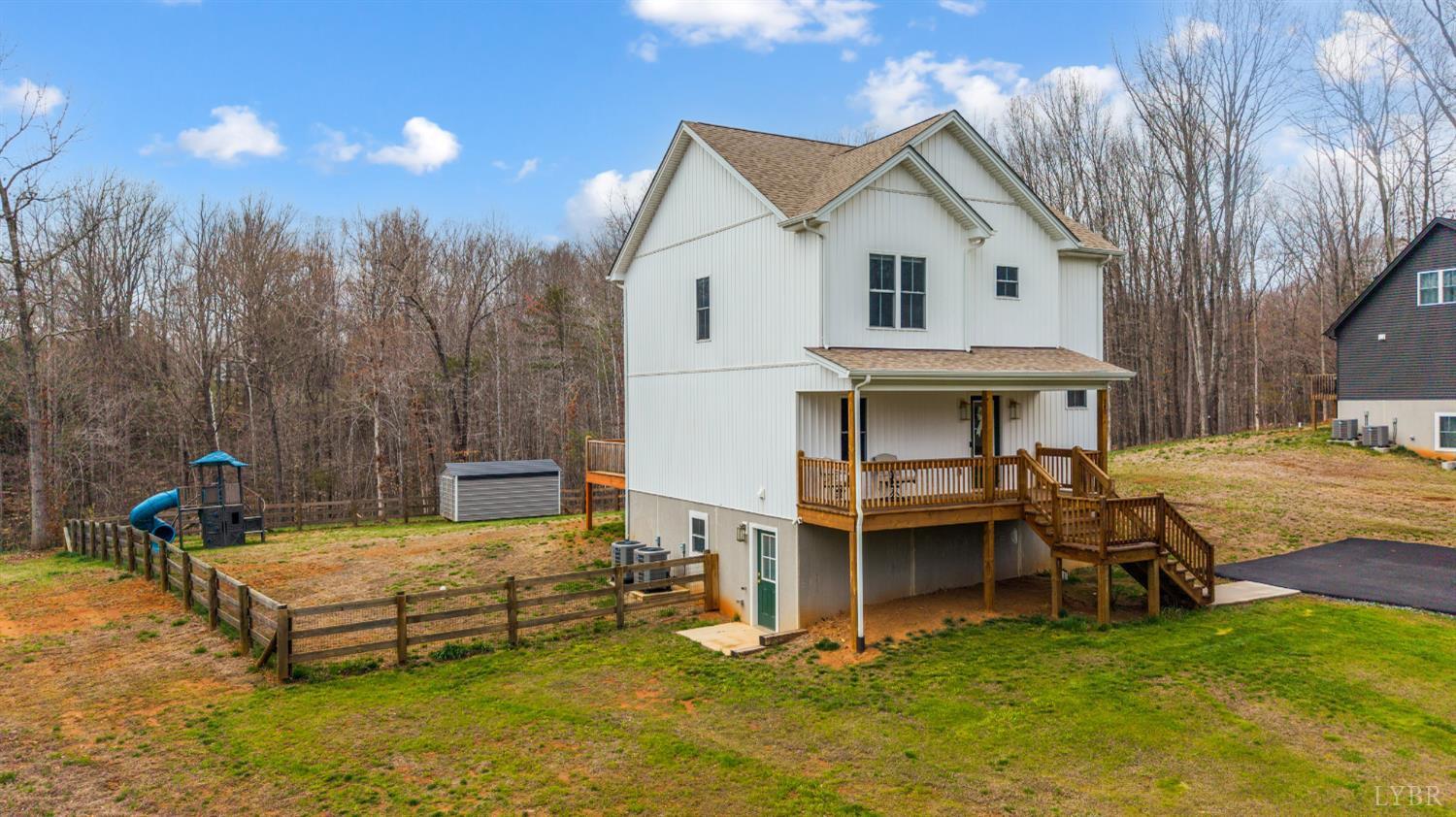 240 Ned Brown Road Amherst, VA 24521 - Photo 42 of 53 a view of a white house with a big yard and a large tree