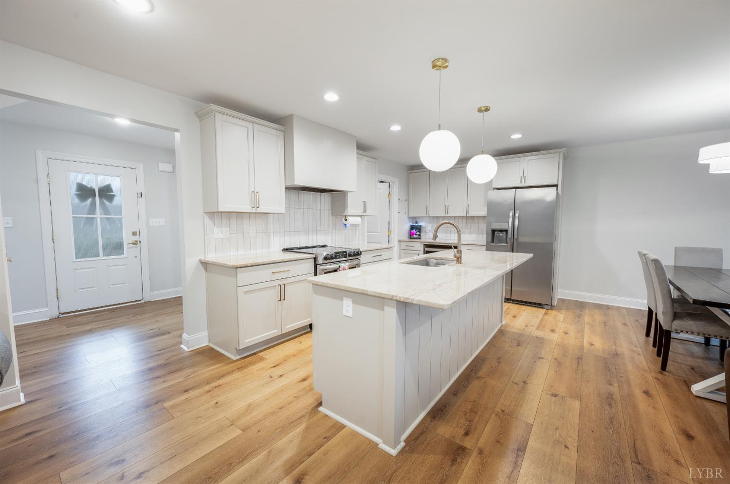 240 Ned Brown Road Amherst, VA 24521 - Photo 10 of 53 a large kitchen with kitchen island a island a sink a center island stainless steel appliances cabinets and a wooden floor
