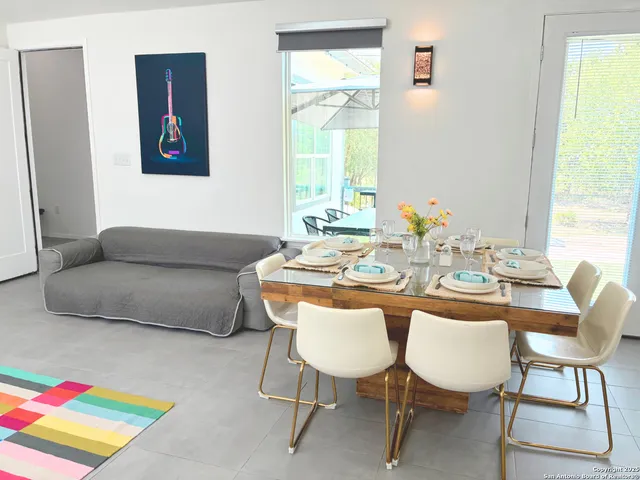 a dining room with furniture and a window