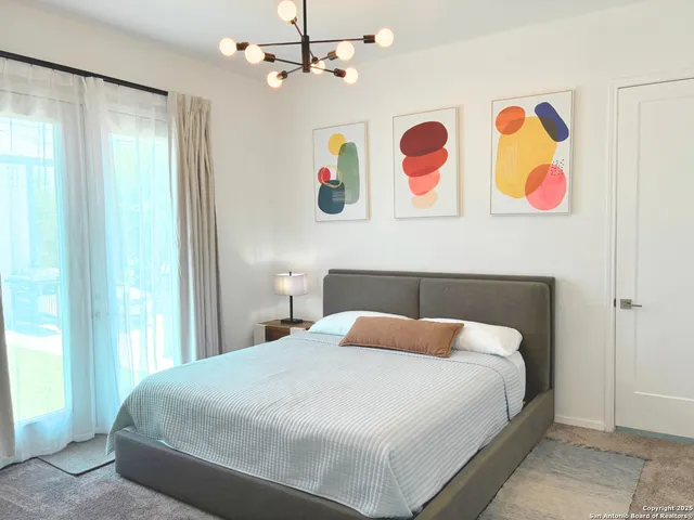 a bedroom with a bed and dresser next to a window