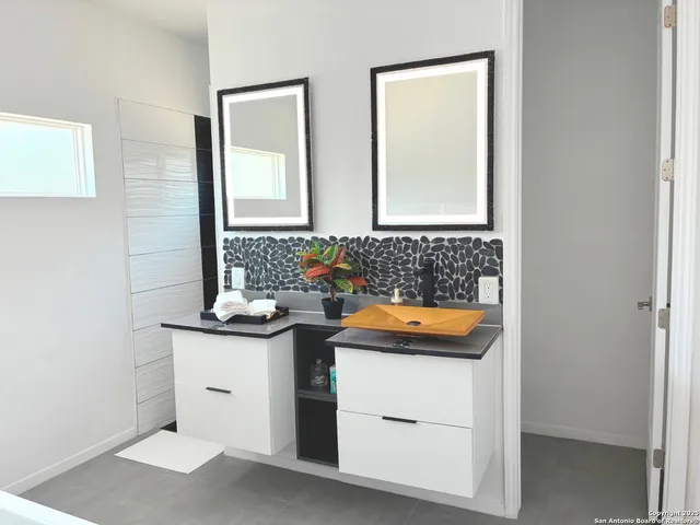 a bathroom with a sink and a mirror